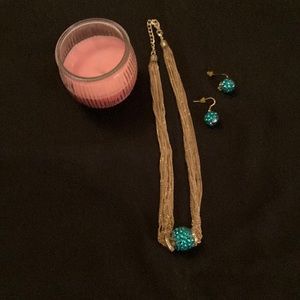 Gold necklace and matching earrings with green ball jewel